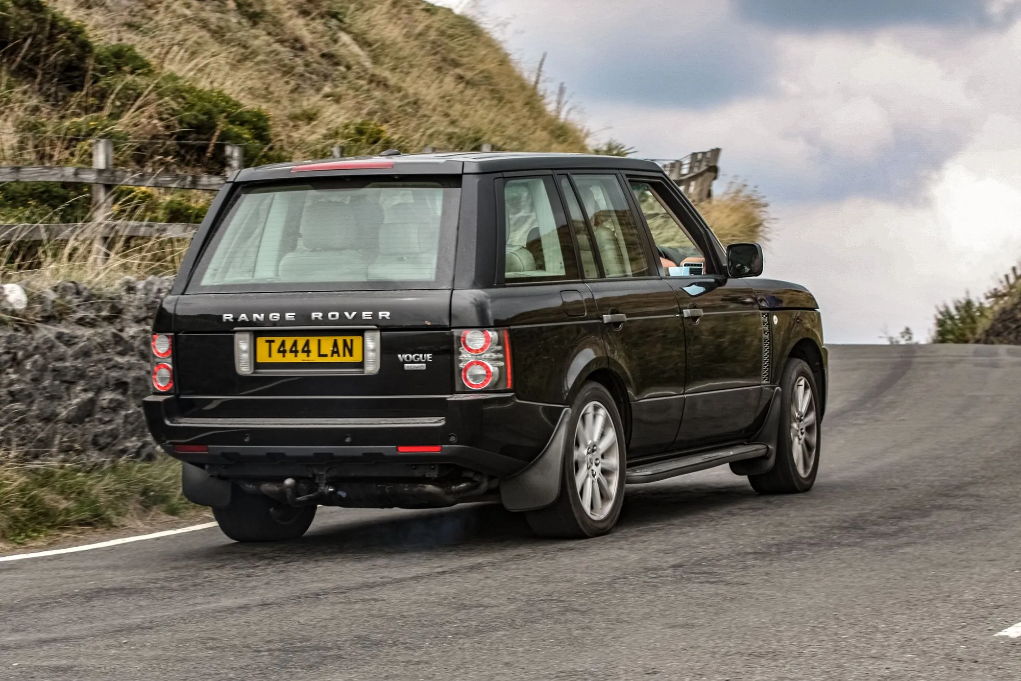 A black Land Rover Range Rover photographed from the rear on a British road